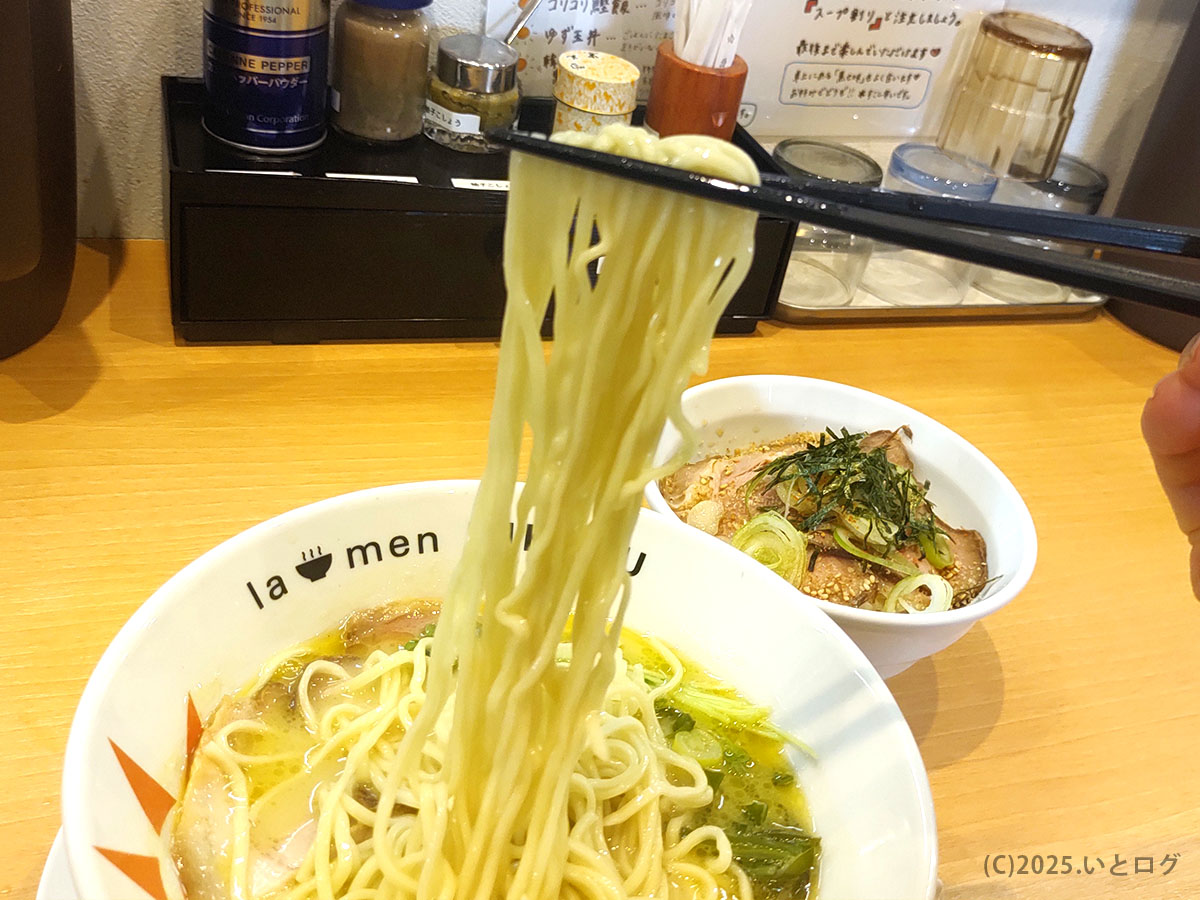 ラーメンニッコウ自家製ストレート細麺をリフトアップ。鶏白湯スープをまとった艶やかな麺線が食欲をそそる瞬間。