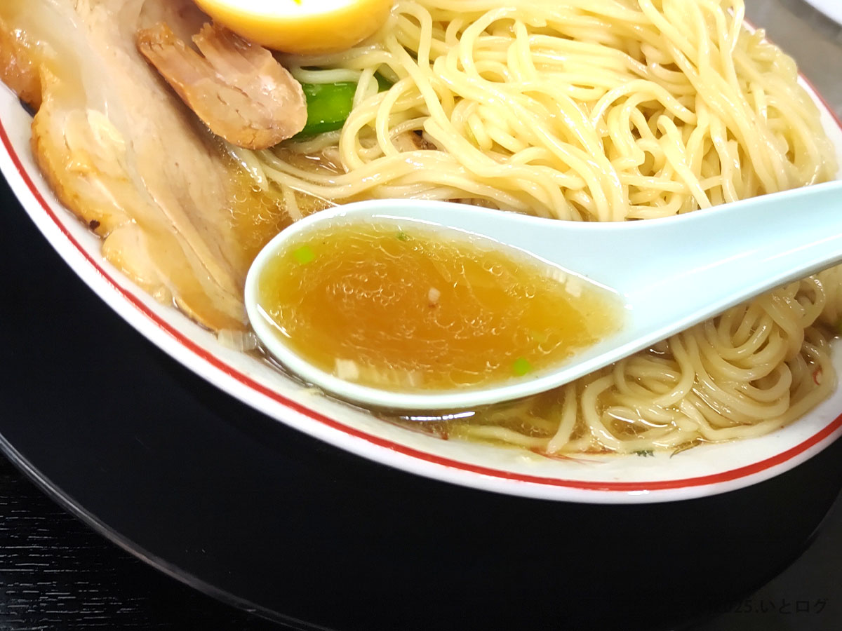 みずさわ屋のスープをレンゲですくった瞬間。透き通る琥珀色のスープは、鶏ガラと魚介の旨みが調和。中華そば本来の魅力を引き出す丁寧な味わい。