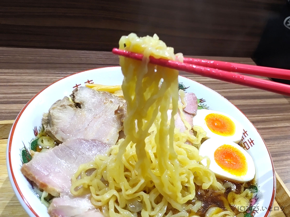 平打ち縮れ麺を箸上げ。じんない中華そば メニュー自慢の多加水麺が光を受けてツヤリと輝く瞬間。