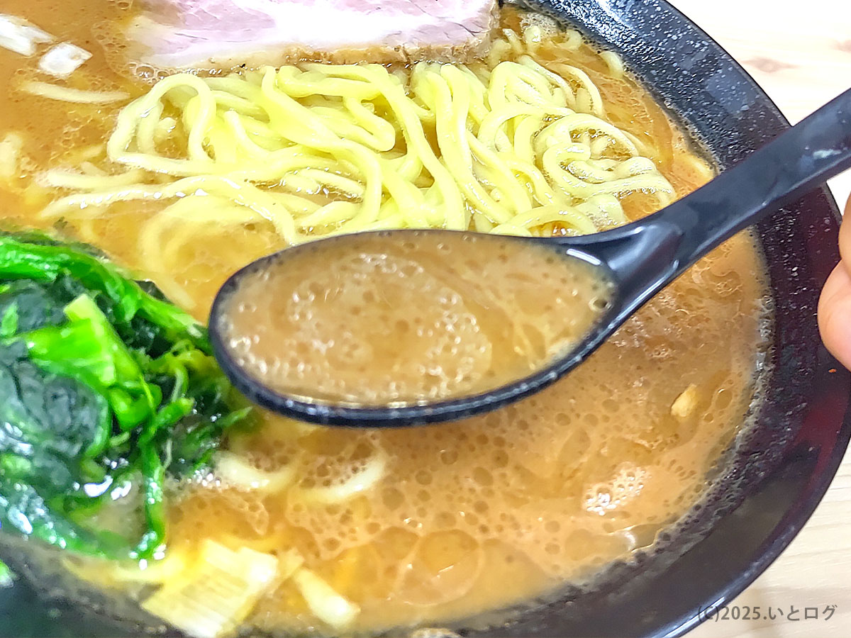 武道家 口(くにがまえ)国分寺のスープをレンゲですくった様子。とろみのある濃厚豚骨醤油の質感が分かり、武道家系家系ラーメンの力強い味わいを象徴する一枚。