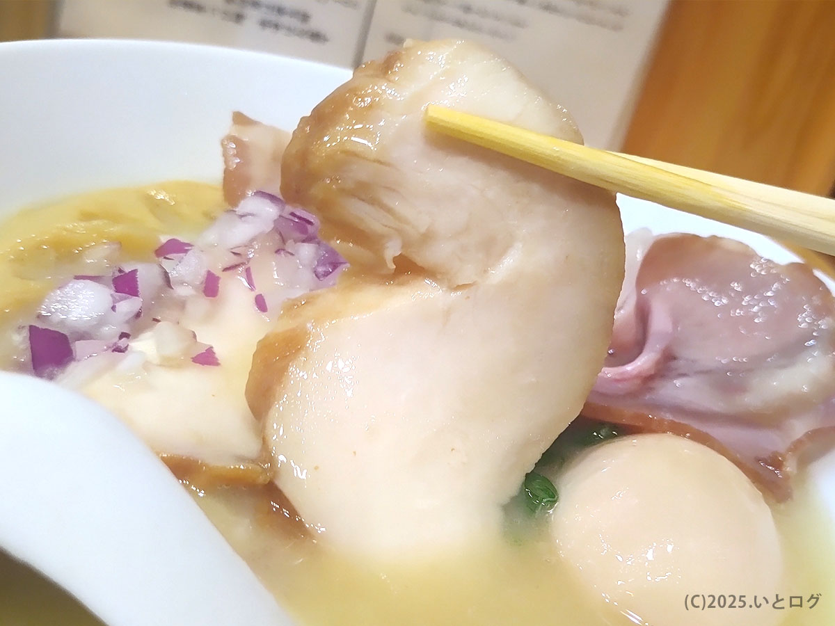 ふっくら鶏むねチャーシューを持ち上げたところ。香ばしいオイルが立ちのぼり食欲を刺激