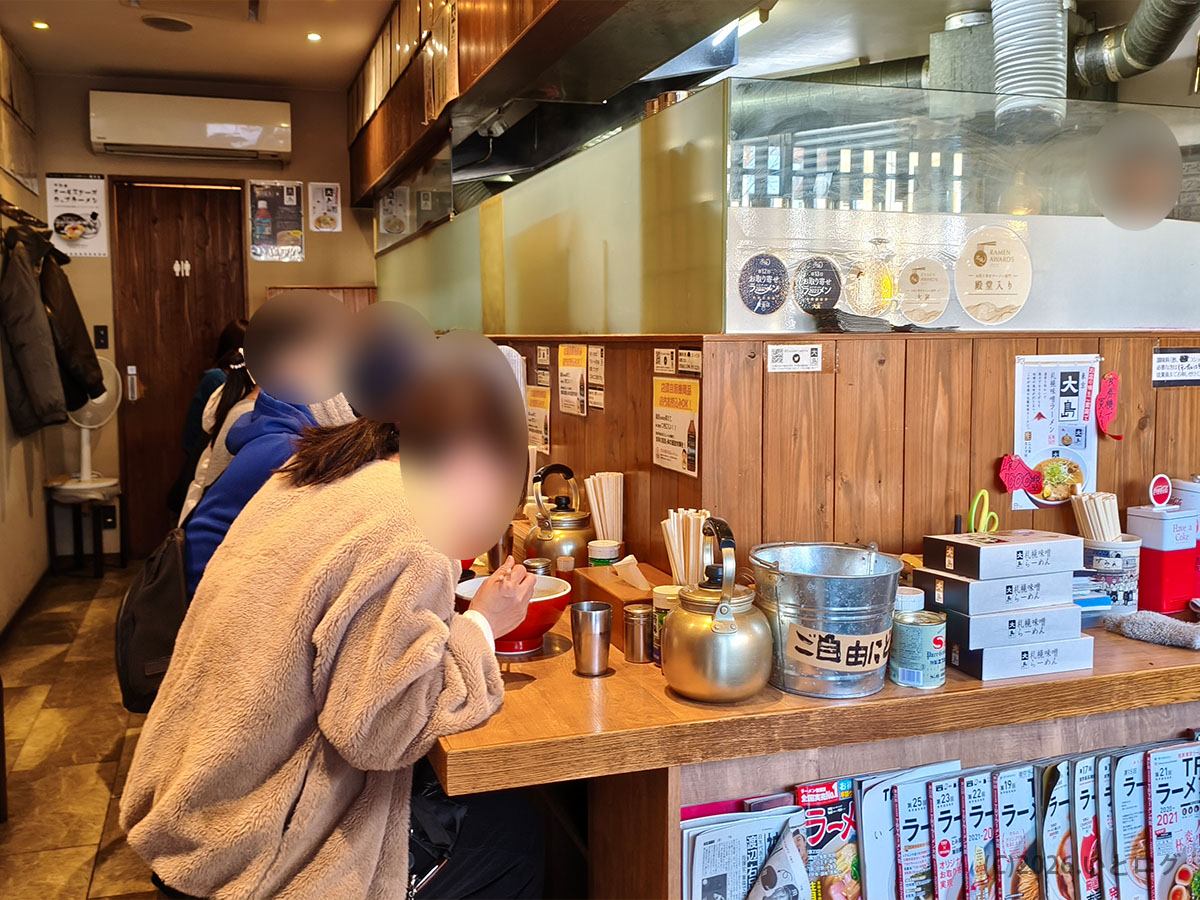 江戸川区大島にあるラーメン店「大島」の店内カウンター席の様子。落ち着いた雰囲気で食事を楽しめる空間