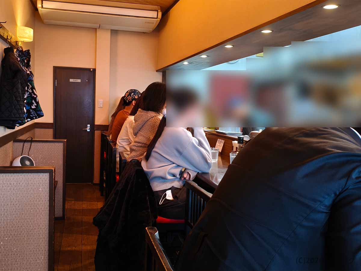 麺処 と市の店内カウンター席の様子。奈良・橿原市の人気ラーメン店らしく、昼時は多くの客で席が埋まっていた。