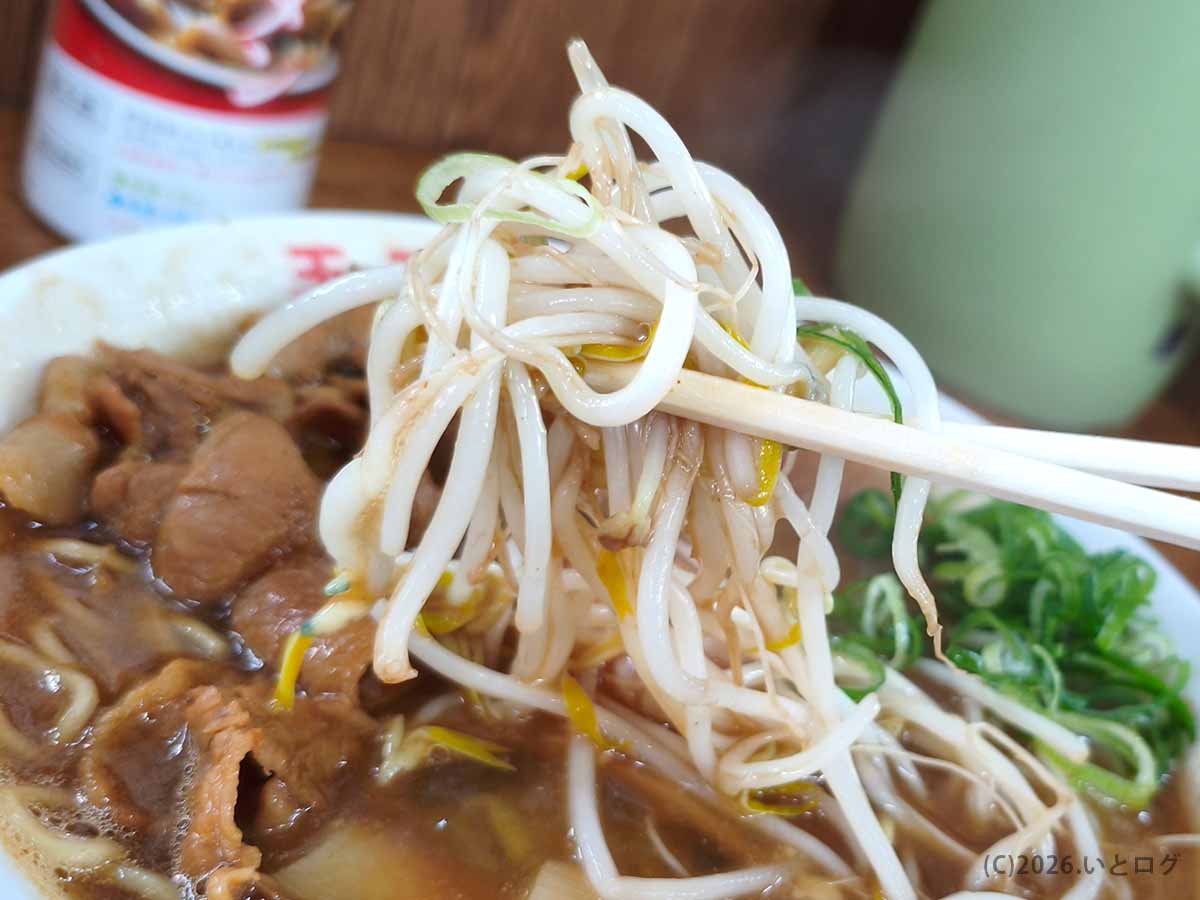 王王軒 本店の徳島ラーメンから箸で持ち上げたもやし、肉入りスープとネギが見える一枚