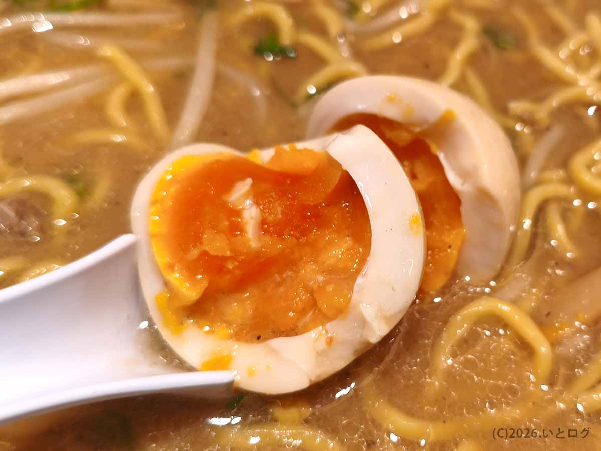IOrIのラーメンにトッピングした味玉の断面。半分に割るとオレンジ色の半熟黄身がとろりと広がっている。