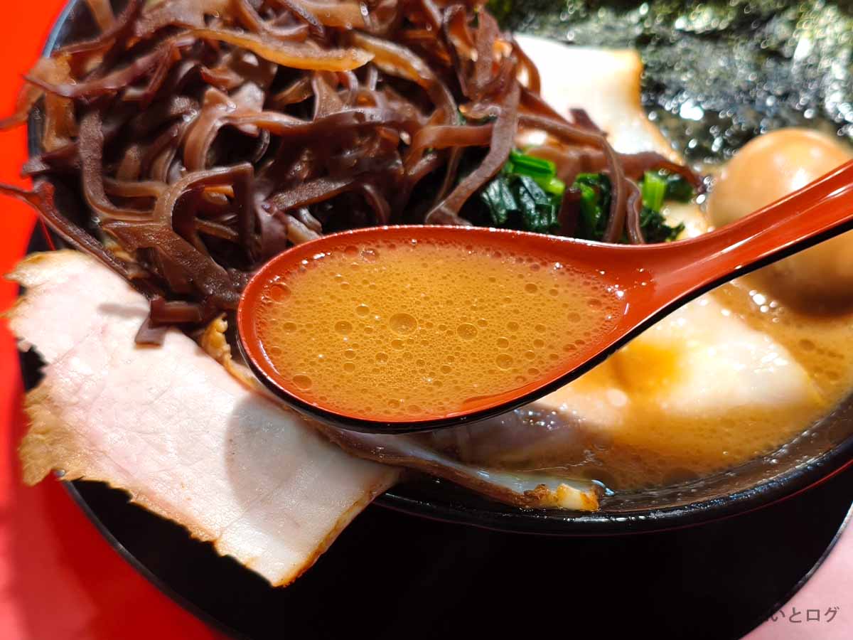 王道乃印 秀道家のラーメンに使われる濃厚な豚骨醤油スープをレンゲですくった様子