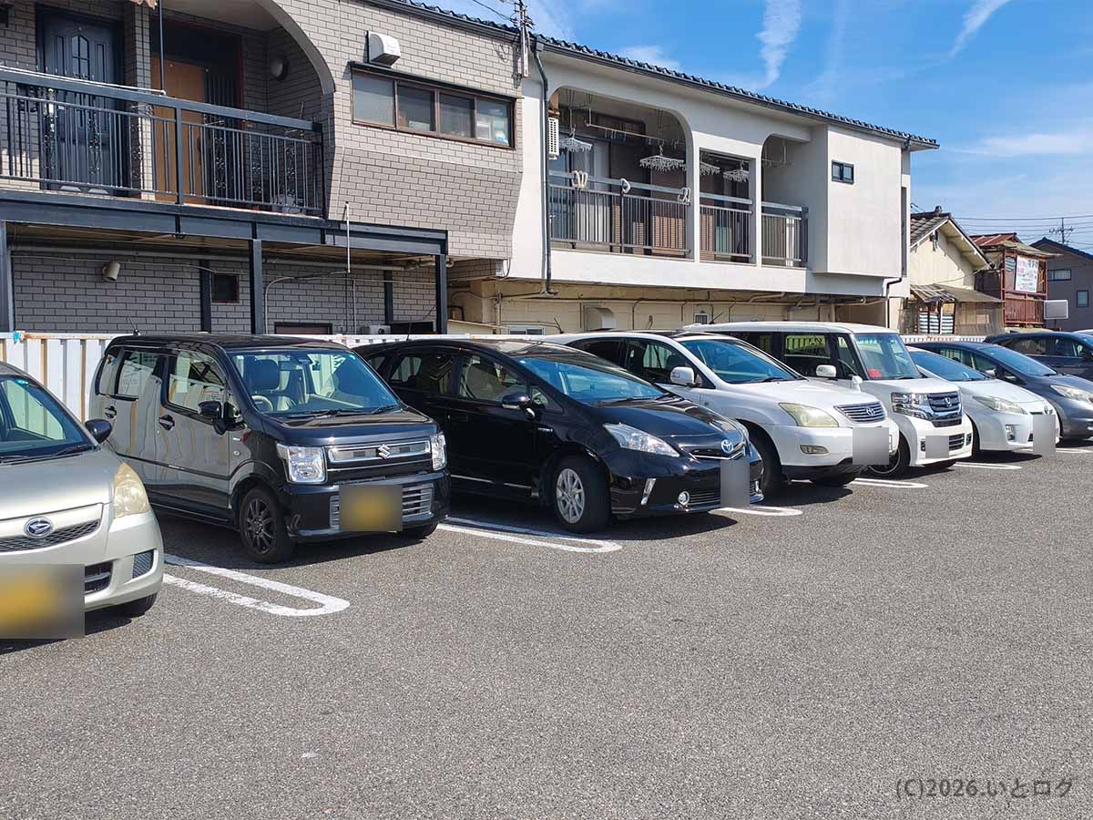 甲府市上石田にある中華 福吉の店舗南側駐車場。建物沿いに複数の車が並んで駐車している様子