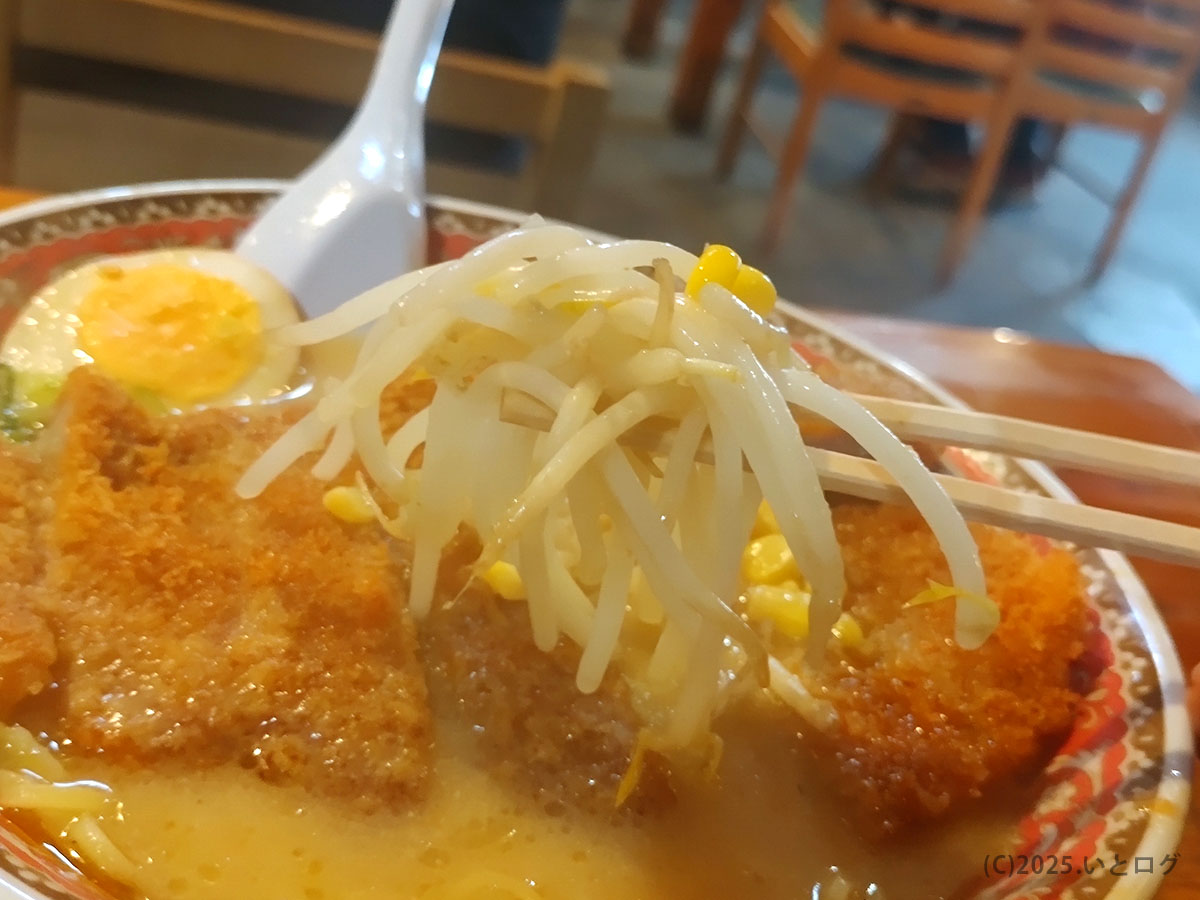 シャキシャキもやしと甘いコーンを箸で持ち上げるカット。味噌カツの衣とスープのコントラストが映え、自由軒 大津 メニューの野菜感を強調。