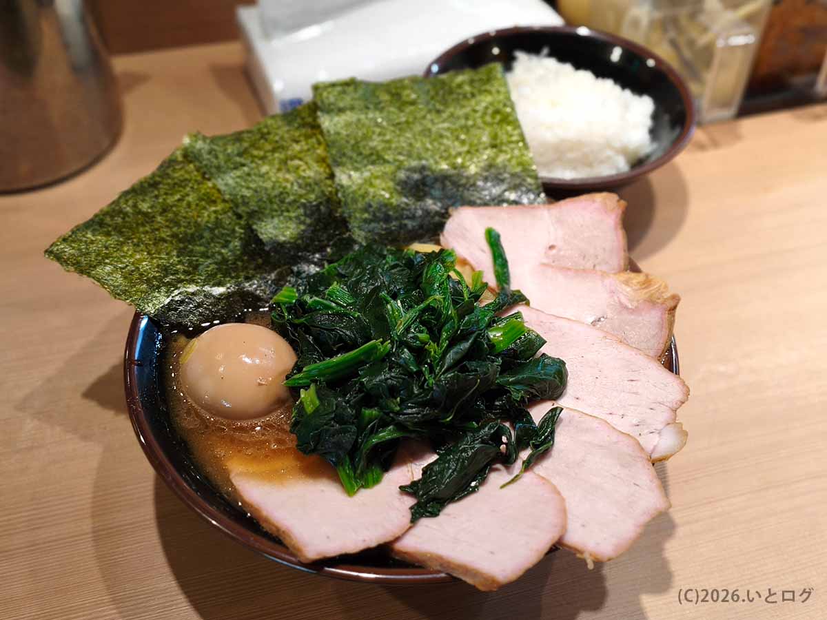 池袋西口の家系ラーメン店「皇綱家」の皇綱特製ラーメン。海苔・味玉・ほうれん草・チャーシューがのり、奥にライスも見える。