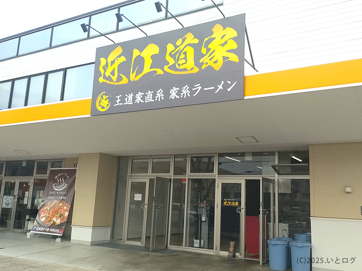 黒地に金文字の看板が目印の近江道家外観。広い駐車場付きで車派も安心、ガラス張りの入口が開放的。