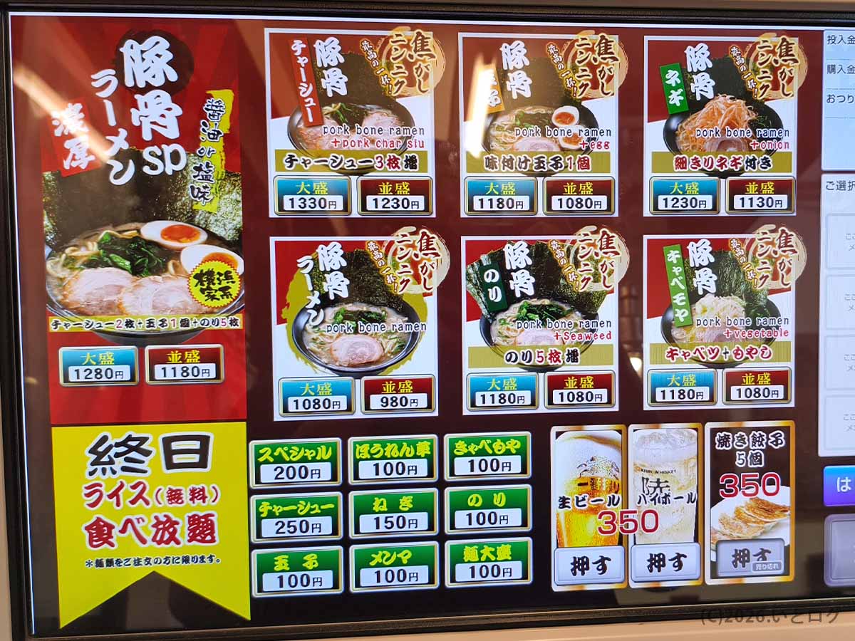 横浜家系ラーメン巣鴨家の券売機。豚骨ラーメンSP、チャーシュー麺、味玉、ネギ、海苔などのメニューと価格、無料ライス食べ放題の案内